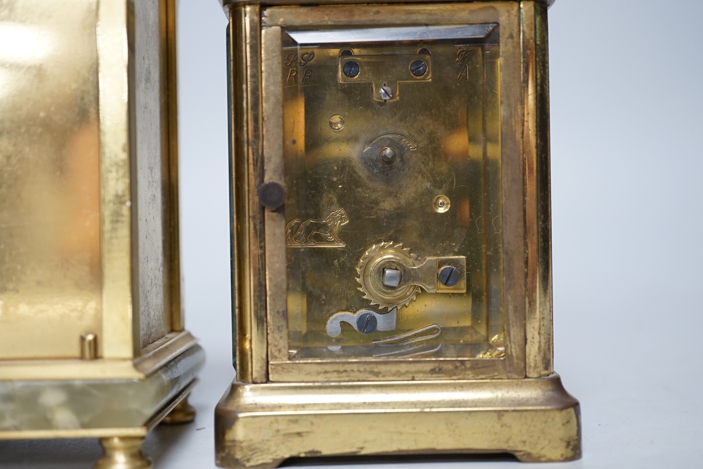 Two carriage timepieces comprising a brass example and one green onyx mounted with quartz movement, largest 17cm high